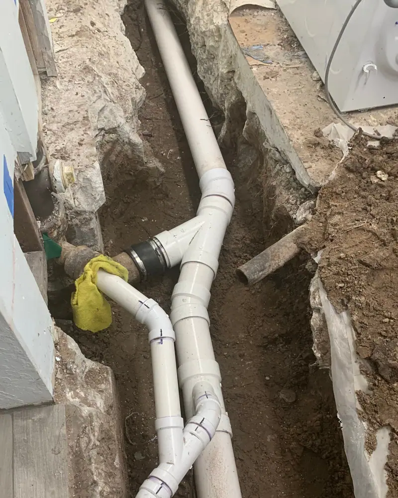 New PVC drain fittings set in an open trench by 3 J's Plumbing