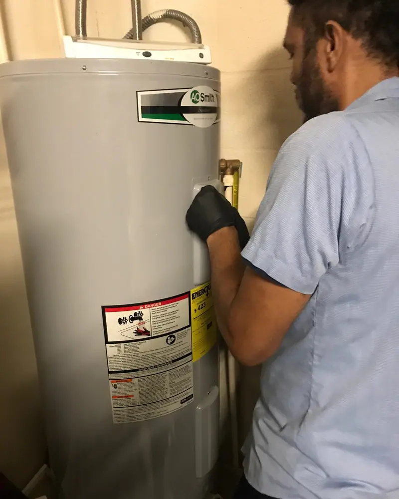 3 J's plumber installing an A.O. Smith water heater