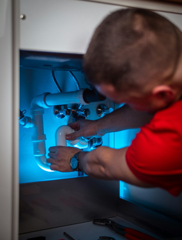 plumber repairing a damaged pipe