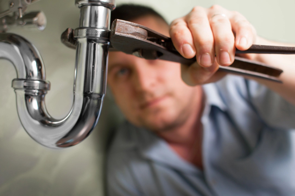 Plumber repairing a pipe in a residential home in Oldsmar